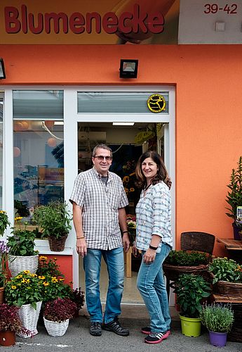 Besitzer der Blumenecke vor ihrem Stand